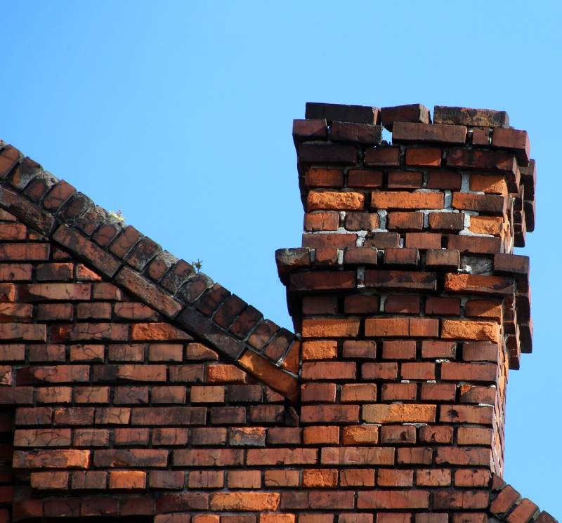 Signs Your Hingham Home Needs a Chimney Inspection Damaged chimney on an Hingham home showing cracks and missing mortar